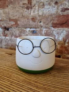 Nerd with glasses indoor plant pot